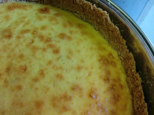 The finished cheesecake, with tiny flecks of ground cardamon visible